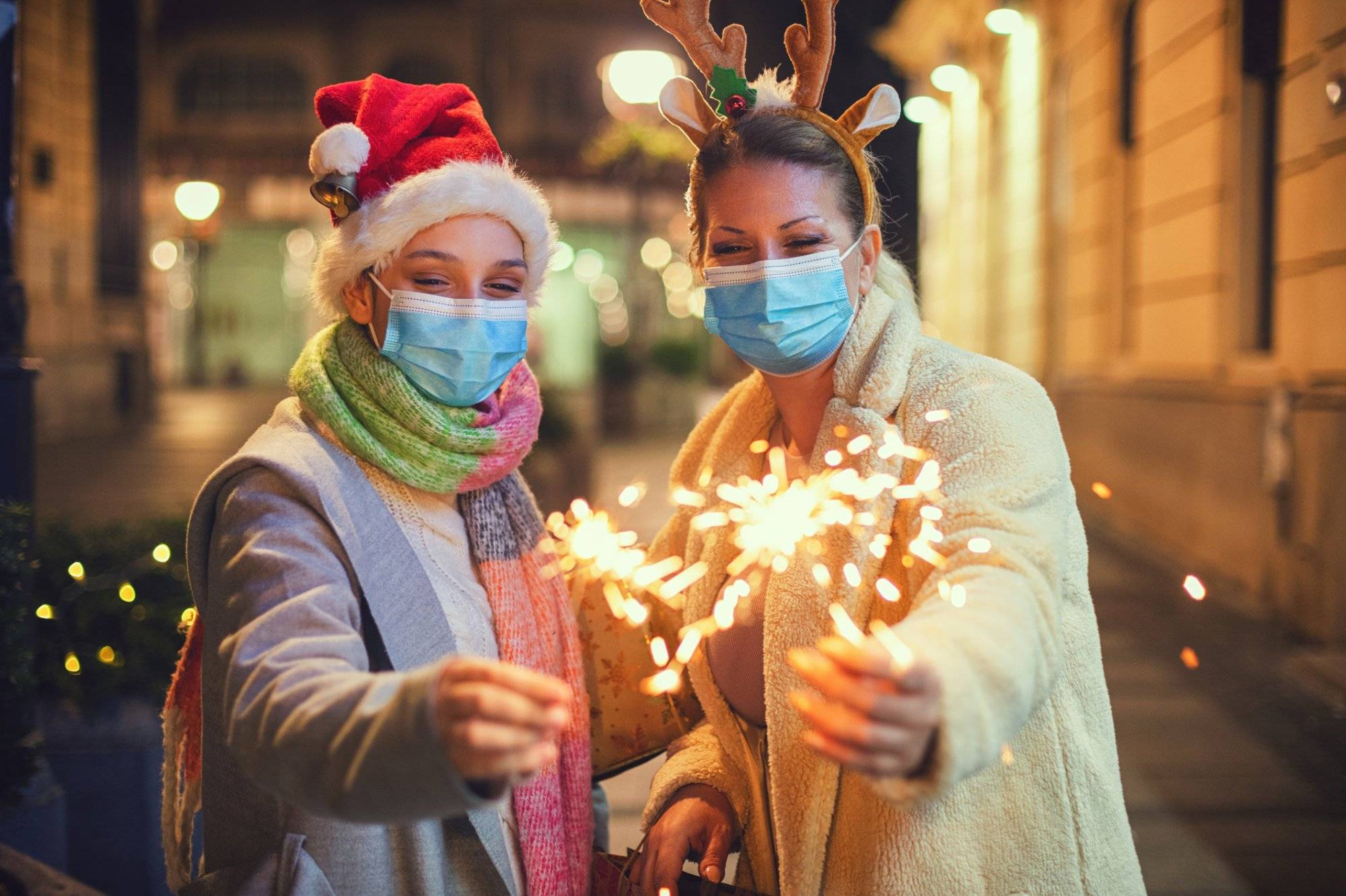 Family having fun while celebrating Christmas during COVID-19 pandemic. They wears a protective mask to protect from coronavirus COVID-19. Family having fun while celebrating Christmas during COVID-19 pandemic. They wears a protective mask to protect from coronavirus COVID-19.