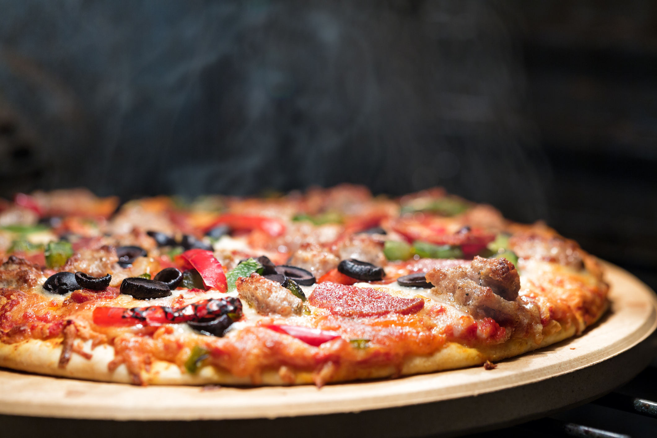 Hot Steaming Pizza in Oven