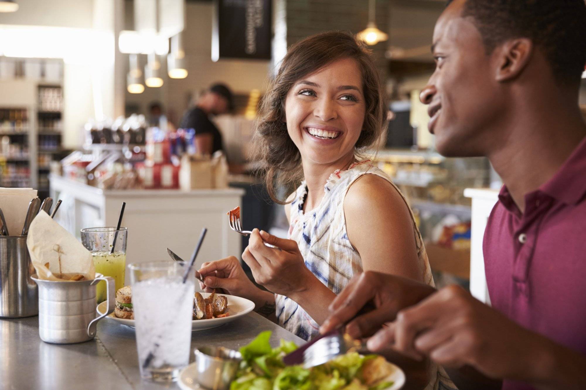 Couple Enjoying Lunch Date In Delicatessen Restaurant Couple Enjoying Lunch Date In Delicatessen Restaurant