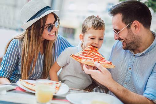 Portrait of happy family spending time in pizzeria Portrait of happy family spending time in pizzeria