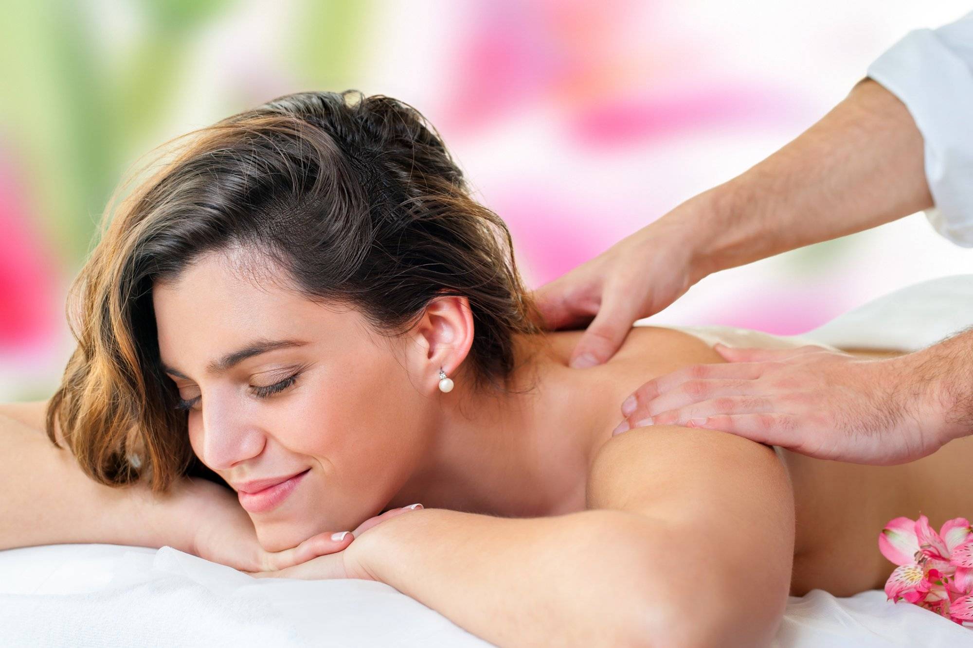 Young woman enjoying back massage. Young woman enjoying back massage.
