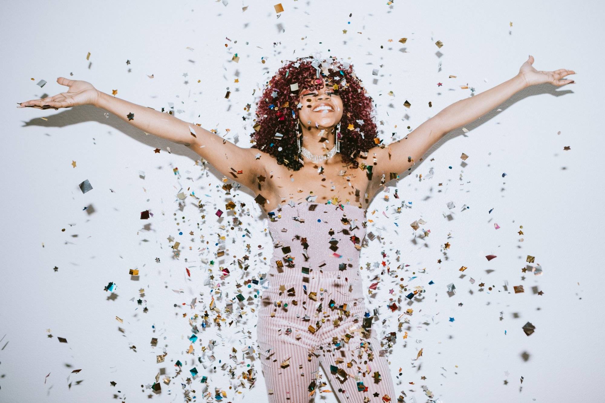 Generation Z Young Woman Celebrates With Confetti