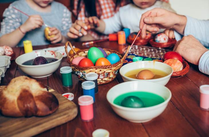 Happy family painting Easter eggs