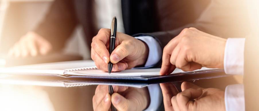 Hands signing document