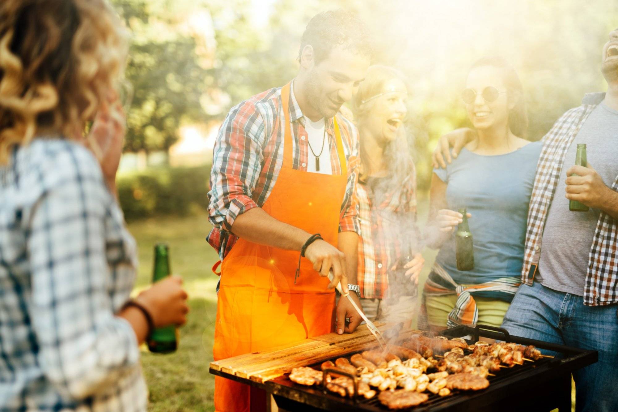 Young people grilling outdoors